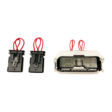 Three Duramax CAN bus bypass plugs with red jumper wire loops